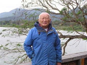 Jerry standing by lake in China